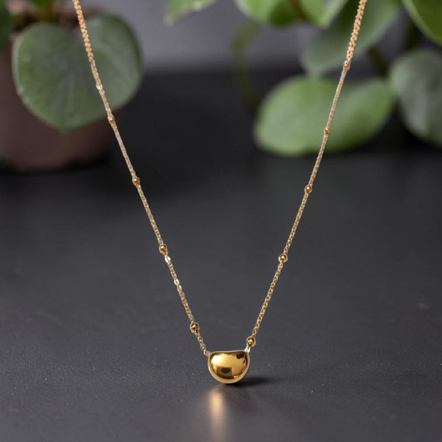 Minimalist 18K gold plated heart-shaped pebble pendant on a beaded chain, tarnish-free and waterproof stainless steel jewelry for women.