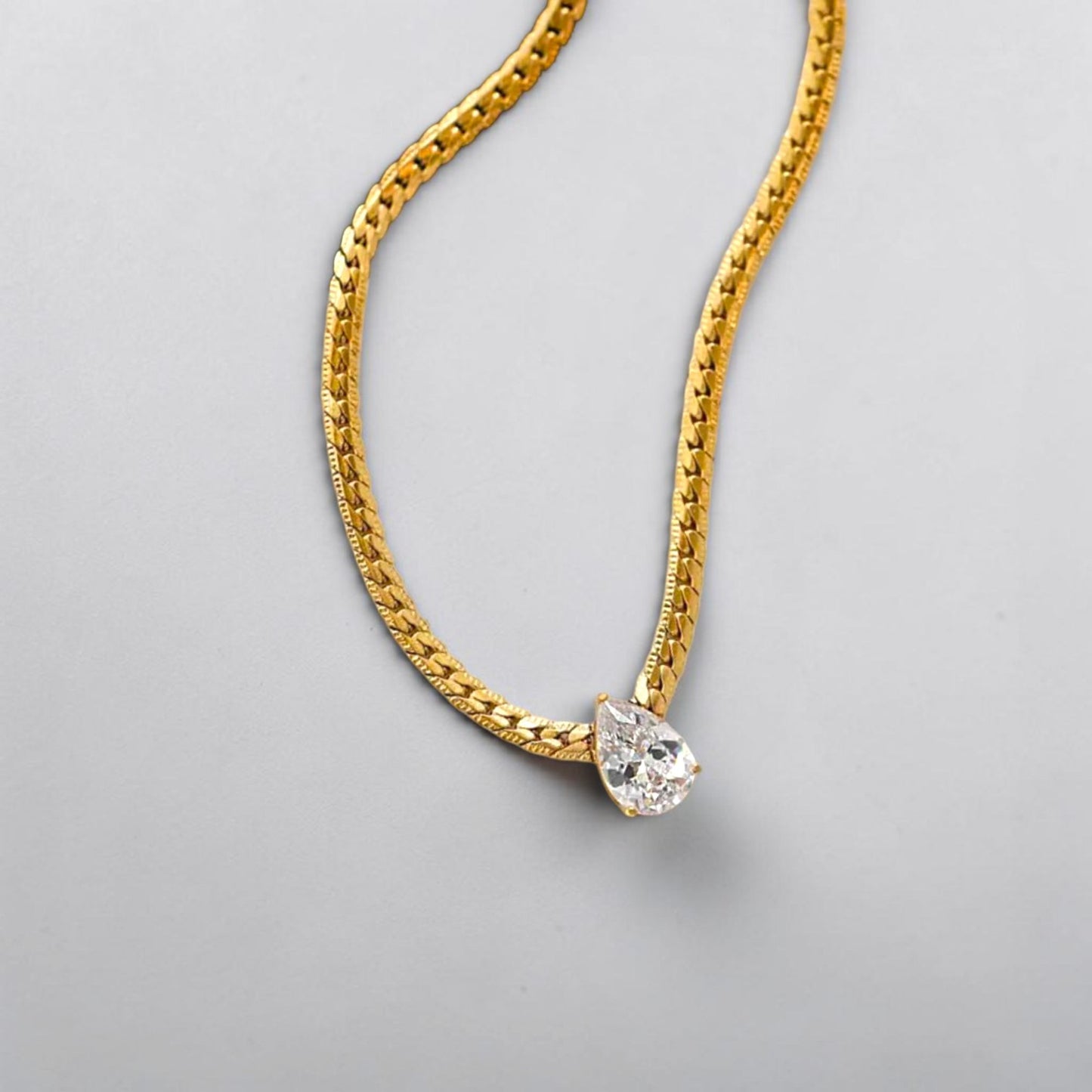 Elegant gold teardrop pendant necklace, 18K gold plated stainless steel with CZ stone.

Minimalist pear shaped cubic zirconia pendant on gold chain waterproof everyday jewelry in Pakistan Efforro
